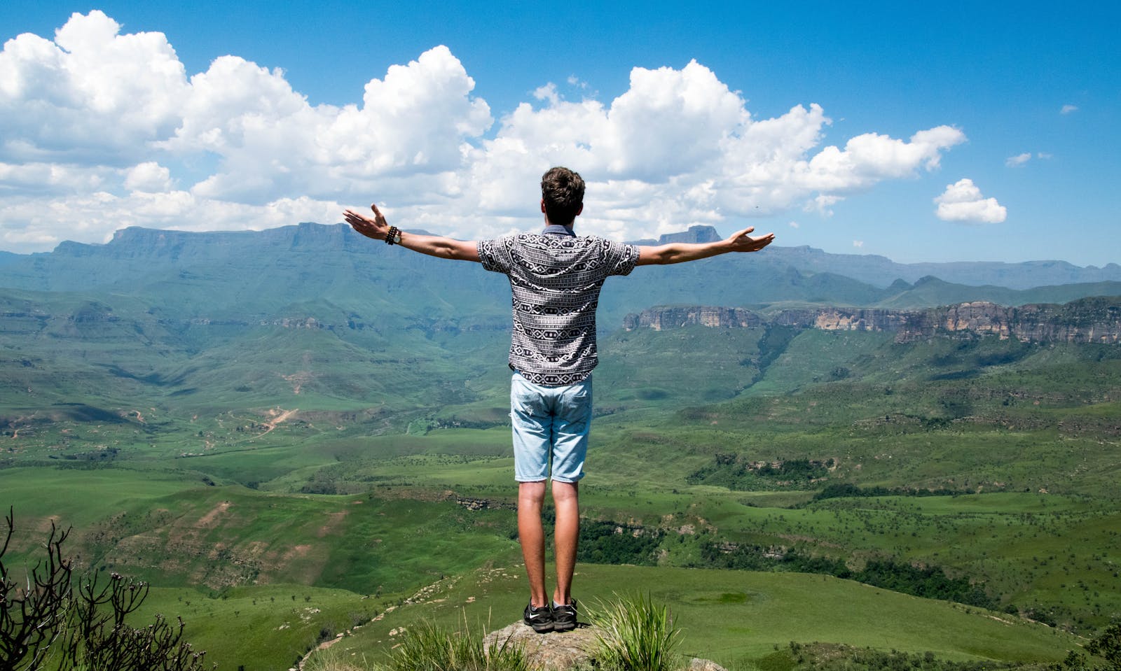 Man Wearing Grey Shirt Standing on Elevated Surface