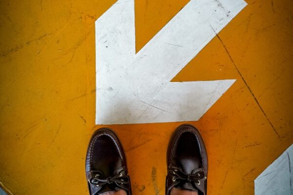 person wearing black leather shoes